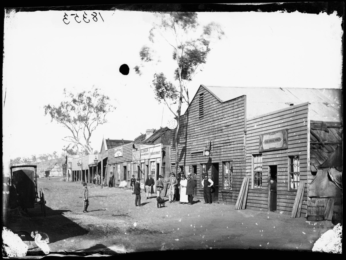 a2822282 – Mayne Street, Gulgong, looking east from Colonial Wines, C Giugni Jeweller, the Prince of Wales Theatre, S Green’ Hairdressing Salon and Dillon’s Hotel, Gulgong. a2822282 - Mayne Street, Gulgong, looking east from Colonial Wines, C Giugni Jeweller, the Prince of Wales Theatre, S Green' Hairdressing Salon and Dillon's Hotel, Gulgong.